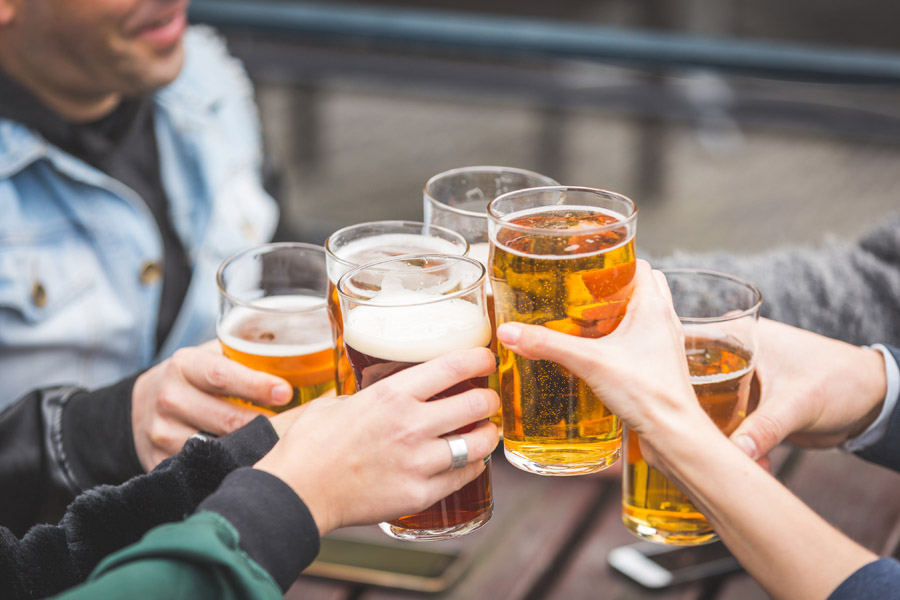 Liquor Liability Insurance - Group of Friends Cheering with a Beer
